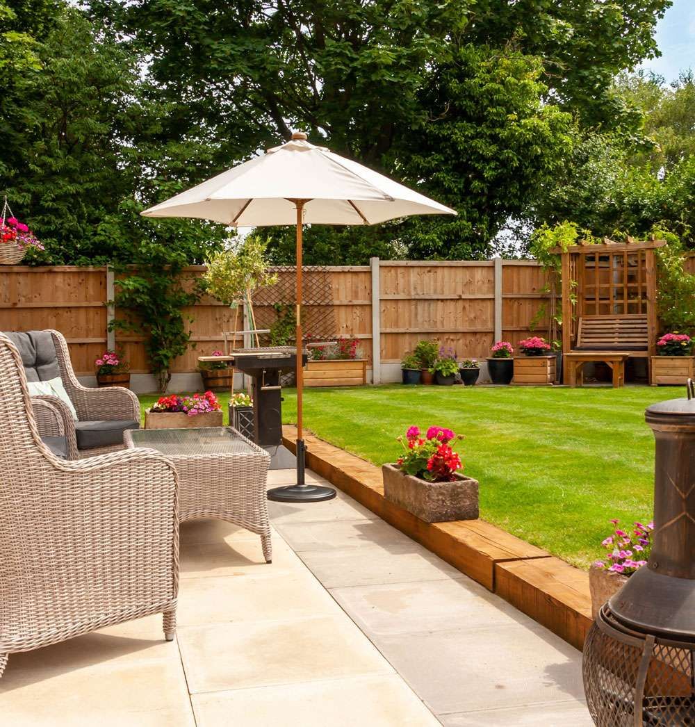 patio area with trees in the background Dimension Landscapes & Driveways 